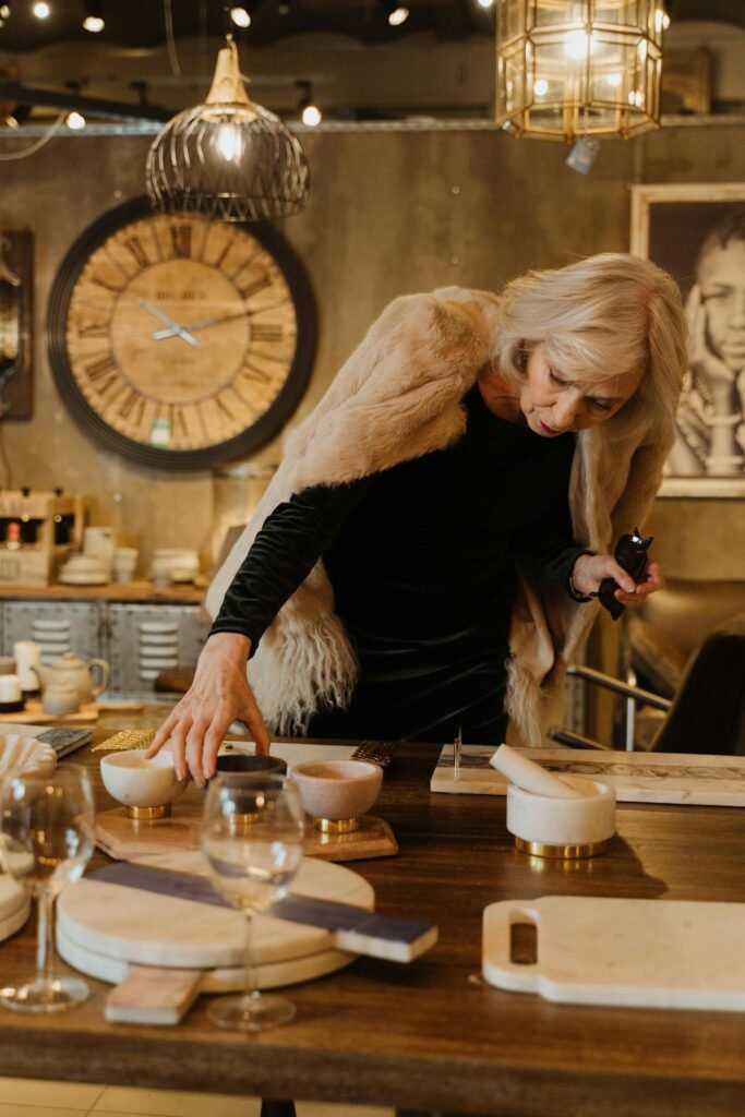 Senior woman explores merchandise in a stylish store interior, showcasing elegant decor and fashion.